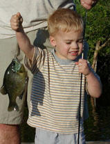 Small child holding his catch