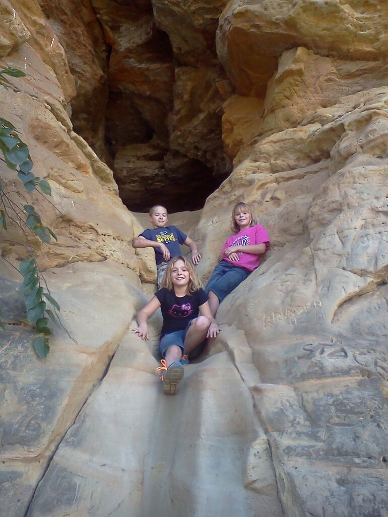 Kids enjoying the Slide Cave on the Buffalo Track Canyon Nature Trail at Kanopolis State Park