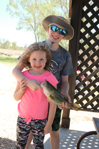 boy and girl holding fish